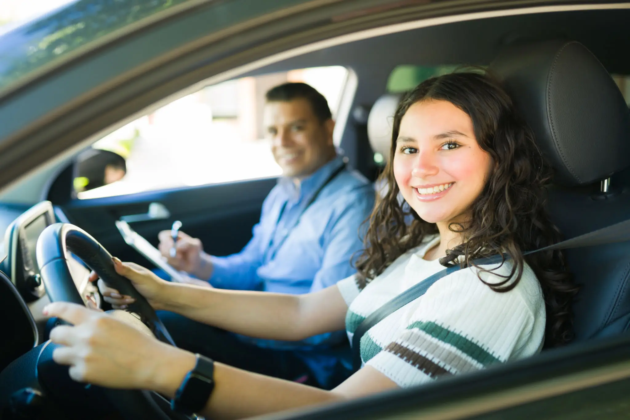 A woman sitting in the drivers seat of a car.